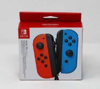 A boxed as new Nintendo Switch Joy-Con Controller Pair in Neon Red/Neon Blue.
