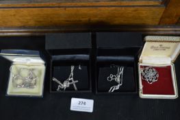 Four Silver Pendants and Chains