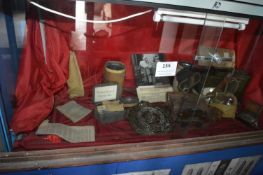 Contents of Showcase to Include Brass Plaque, Gas Mask, Ammunition Box, Gas Eye Shields, Compass and