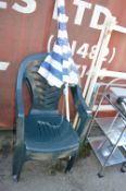 Two Plastic Garden Chairs and a Garden Parasol