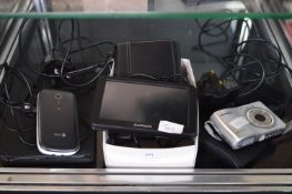 Garmin Sat Nav, Minot Digicam, and a Mobile Phone