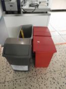 *Four Waste Bins and a Wet Floor Sign