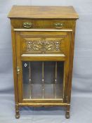 EDWARDIAN CARVED MAHOGANY MUSIC CABINET with single frieze drawer over a carved panel and glazed