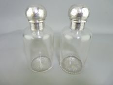 VICTORIAN SILVER TOPPED COLOGNE BOTTLES, a pair, with chase decorated screw mount tops, the