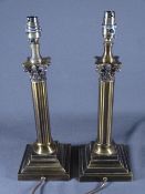PAIR OF BRASS EFFECT TABLE LAMPS with Corinthian style columns on a step base E/T