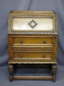CIRCA 1930 CARVED OAK BUREAU having grape and vine detail on pineapple type supports with interior