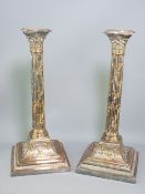SHEFFIELD PLATED CANDLESTICKS, a pair, vine covered Corinthian cap columns on urn and leaf decorated