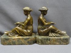 BRONZE SEATED LADY BOOKENDS, 20th Century in the French style on rectangular marble bases with