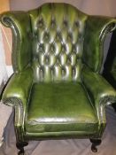ANTIQUE STYLE BUTTON BACK GREEN LEATHER EFFECT WING BACK ARMCHAIR, 109cms H, 83cms W, 52cms seat D