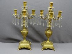 GILT BRASS CANDELABRA LUSTRES, a pair, late 19th/Early 20th Century, with central and four branch