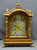 WALNUT CASED TWIN GONG-STRIKE BRACKET CLOCK, arched top with urn and flame finials, gilt metal