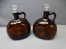 19TH CENTURY AMBER GLASS SPIRIT FLAGONS, a pair, having white metal collar mounts and mother of