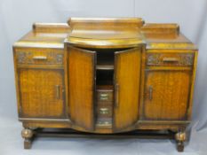 1930s OAK BOW FRONT RAILBACK SIDEBOARD on carved bulbous supports with interior shelves and drawers,