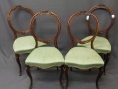 SET OF FOUR VICTORIAN MAHOGANY BALLOON BACK SALON CHAIRS with carved floral top rail detail and