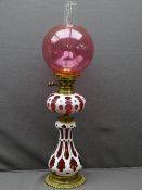 CAMEO CUT GLASS VICTORIAN OIL LAMP, brass with Bohemian type Ruby overlay, bulbous base and font