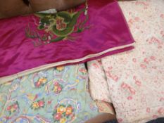 TWO ANTIQUE WELSH FLORAL QUILTS together with a Chinese silk embroidered dragon panel