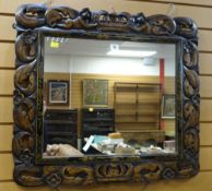 CARVED & JAPANNED ANTIQUE WALL MIRROR the border open work carved with crown, flanking figures and