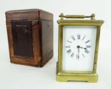 BRASS CARRIAGE CLOCK WITH ROMAN NUMERAL CHAPTER RING in velvet lined case