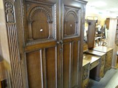 NEAT OAK BEDROOM SUITE with carved decoration to the drawers and sides, comprising two door
