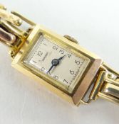 9CT GOLD LADIES WRISTWATCH ON 9CT GOLD EXPANDING BRACELET the face marked 'Dominant', boxed, 12.