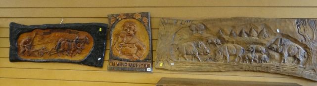 THREE CARVED BLACK FOREST WALL PLAQUES of plough horses, wild boars and a beer swigging monk