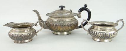 WHITE METAL ANTIQUE THREE-PIECE TEASET of oval form with fluted decoration, marked to the base '