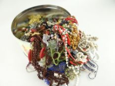 CIRCULAR TIN CONTAINING LARGE QUANTITY OF COSTUME JEWELLERY, BEADS ETC