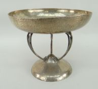 ARTS & CRAFTS HAMMERED SILVER TAZZA shallow bowl raised on three bowed supports on a domed base,