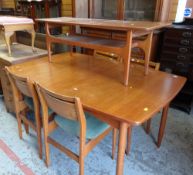 MID CENTURY LIGHT TEAK EXTENDING DINING TABLE with four matching cushioned chairs, together with a