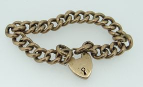 9CT YELLOW GOLD CURB LINK BRACELET with heart shaped padlock, 20.3grams