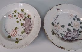 PAIR OF 18TH CENTURY ENGLISH DELFT SHALLOW DISHES interiors naively decorated with manganese, iron-