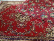 MAINLY RED GROUND WOOLEN RUG with green and brown floral decoration, 270 x 180cms, together with a
