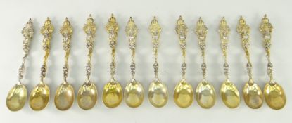 TWELVE UNITED KINGDOM CREST SILVER SPOONS gilded and decorated in relief, six fully hallmarked for
