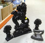 CAST IRON DOOR STOP IN THE FORM OF A RAMPANT LION, together with two wheat sheaf door stops and a