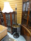 REPRODUCTION OAK STANDARD LAMP with circular shelf and carved wood base