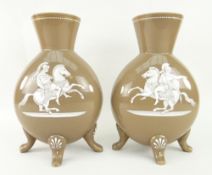 PAIR OF MILK GLASS MOON FLASKS raised over four feet, decorated Roman horseback warriors, 32cms