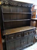 DARK OAK OLD CHARM-STYLE DRESSER with two drawers above a two door cupboard base, 193cms H x 51cms D