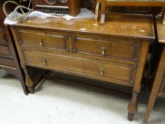 EARLY 20TH CENTURY OAK RAISED CHEST OF DRAWERS, two short above one long with carved frieze to the