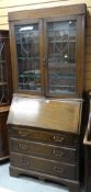 VINTAGE OAK BUREAU BOOKCASE with leaded glass doors, drop down front above three long drawers,