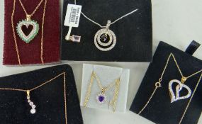 TWO 9CT YELLOW GOLD HEART SHAPED DIAMOND CHIP PENDANTS ON CHAINS, silver target design pendant on