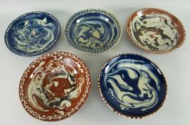 FIVE EWENNY CLAYPITS POTTERY SHALLOW DISHES, all with swirled slip decoration, three in blue and