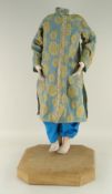 ORIENTAL DRESSED MANNEQUIN ON A WOODEN STAND