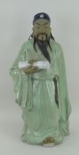 CHINESE STONEWARE GLAZED FIGURE OF AN IMMORTAL HOLDING A SCROLL, 46cms high