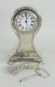 EDWARD VII SILVER BALLOON SHAPED CLOCK raised on four played feet, having Roman numeral chapter