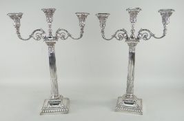 PAIR OF SILVER THREE BRANCH CANDELABRA of Classical form with Corinthian columns and scrolling
