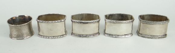 SET OF FOUR 800 SILVER NAPKIN RINGS, together with another silver British napkin ring (5)