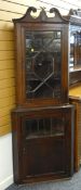 TWO GEORGE III HANGING CORNER CABINETS, one with swan neck pediment and astragal glazed doors, the