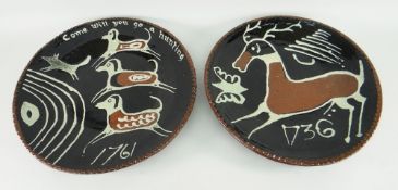 TWO SLIP DECORATED POTTERY CHARGERS BY D. WEAKE of fox hunting and of a stag with butterfly, slip
