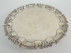 EDWARD VII SMALL SILVER SALVER having scroll and pointed border raised on three scroll feet,