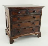 CHARMING GEORGE III STYLE MAHOGANY MINIATURE CHEST OF DRAWERS, two short, three long, on bracket